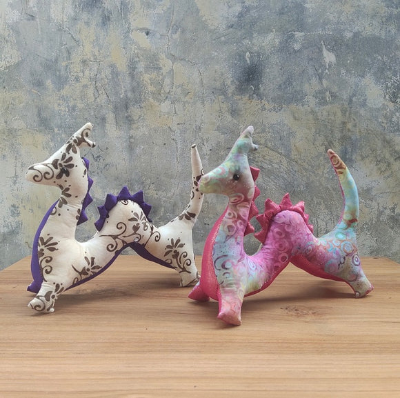 <transcy>Dragon plush toys (white dragons, rainbow dragons) that carry the sacred energy of Bali</transcy>